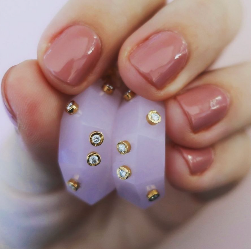 Thumbnail: Pink quartz gemstone earrings in detail. Pair of half precious stone earrings with gold and diamond sparkles.