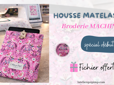 Housse matelassée pour tablette en broderie machine (ITH), modèle Bertille, présentée devant une brodeuse — tuto spécial débutantes