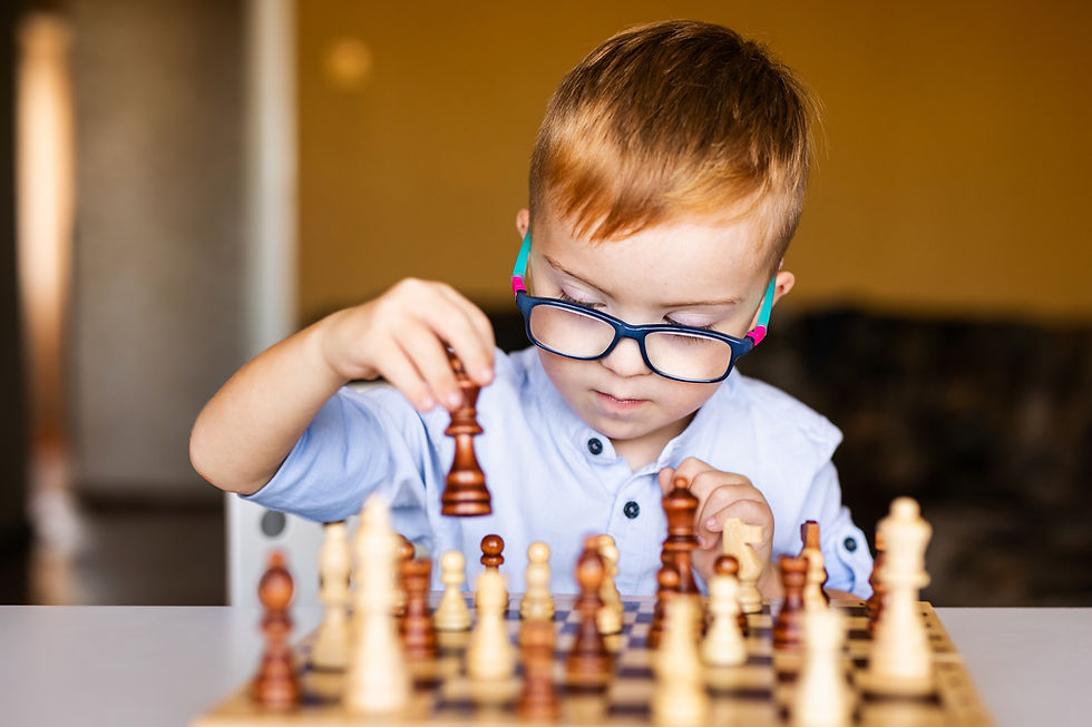 vecteezy_ginger-boy-with-down-syndrome-with-big-glasses-playing-chess_51191434.jpg