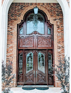 Oversized wood door with glass windows that has been sanded and stained by a door refinishing company near me, Fort Worth Door Refinishing