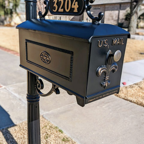 Black iron decorative mailbox post with custom gold patina painted house numbers showing professional finish in Fort Worth neighborhood. Door refinishing near me. Dallas door refinishing. Door renew. Door painting. Door staining. Luxury iron work near me. 