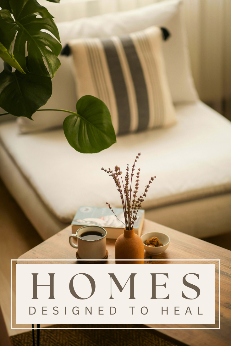 Cozy setting with a plant, striped pillow, and a table holding coffee, a vase, a book, and snacks.
