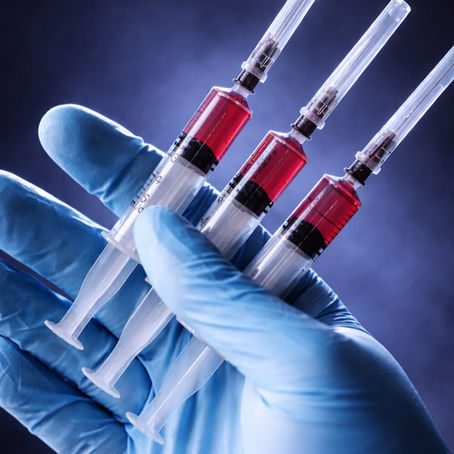 Clinical gloved hand holding injectable peptides