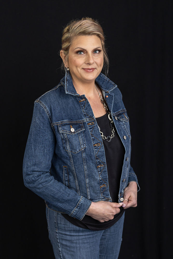 Blond woman in denim jacket and jeans