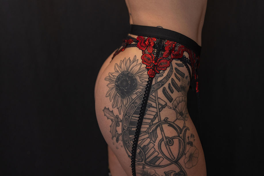 Sexy Central PA boudoir photography session with a garter and tattooed model