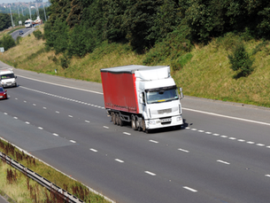 Red and white HGV on UK motorway