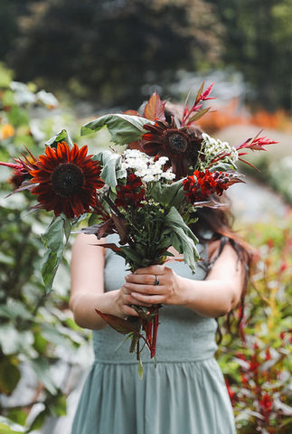 A woman holds up a bouquet of flowers at The Fields at Laurel Glen Farm in Shelton, CT.