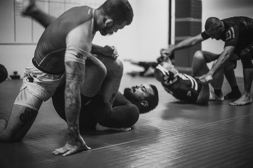 Students training no-gi jiu jitsu in pairs on the mat at Renzo Gracie Portland