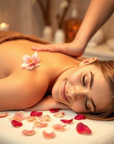 A serene spa setting with a person lying face down on a massage table, receiving a relaxin
