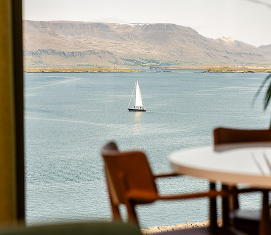 view from ský showing mountains, ocean and a boat