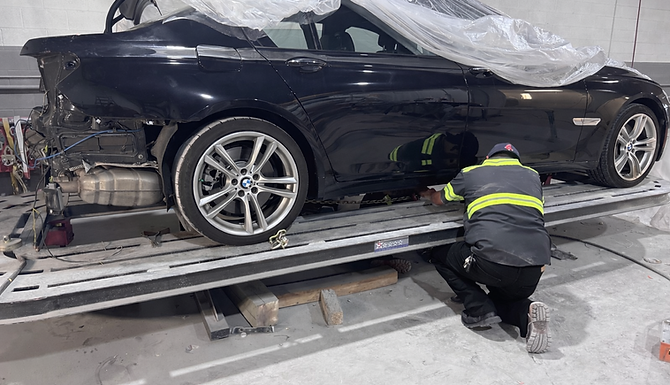 Wrecked BMW on frame puller