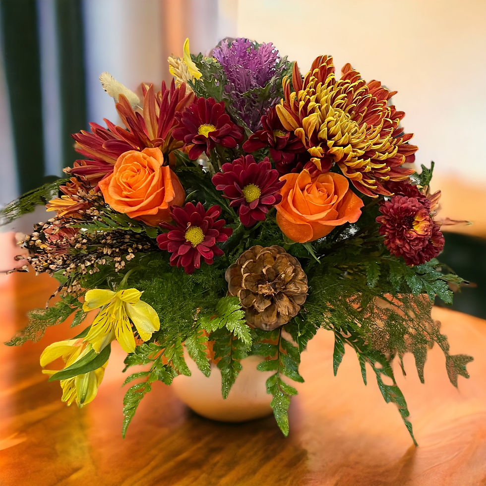 Thumbnail: A mix of orange, burgundy and yellow flowers and pincones.