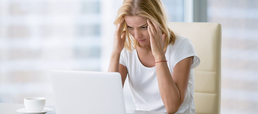 woman working on the computer with a headache