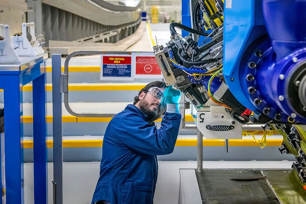 A mechanic prepares to operate the automated fibre placement machine that builds the spars for the first 777-8 Freighter’s wings. (Marian Lockhart photo)