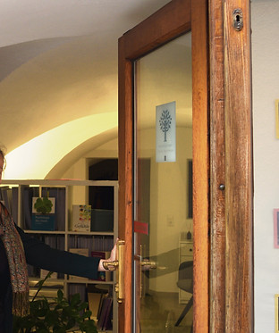 Photo of the practice entrance, Ninna holding the door open.