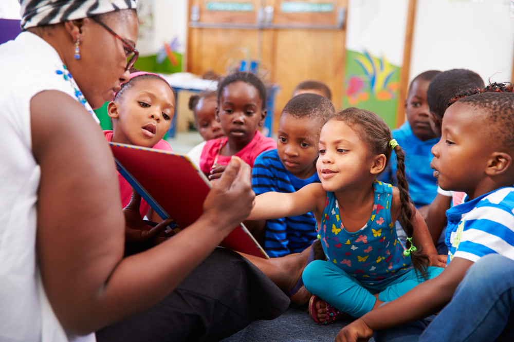 A teacher reading with young students