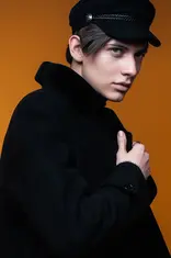 Male professional model in black suite on orange backdrop for agency test shot at LPS Headshot Studio Bangkok