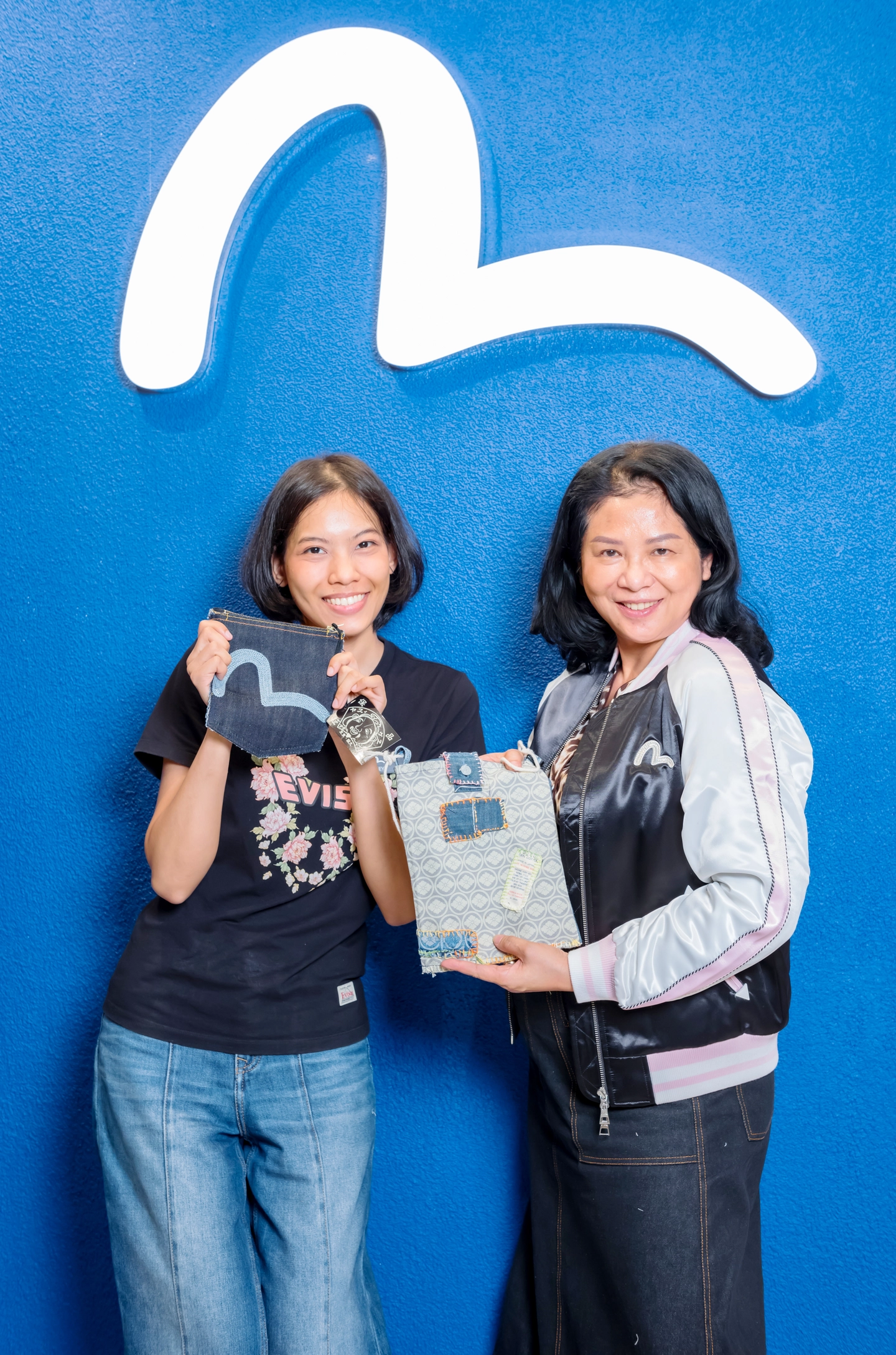 visitors customising evisu denim crossbody bags with patchwork and embroidery at evisu bangkok flagship anniversary event by GIGIPAYNE