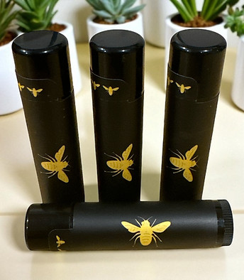 Four Bee The Goat lip balms with gold bee logo