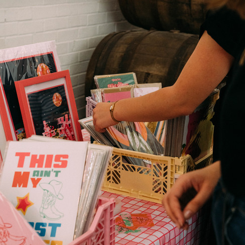 People looking at looks of handmade prints at Salad Days Market