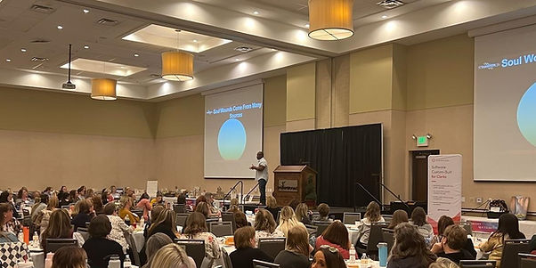 Ron Williams Speaking in front of a large audience