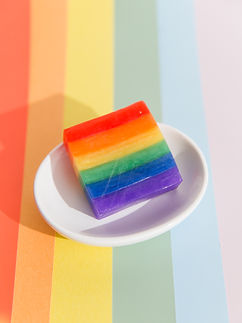 Rainbow product on a plate with a bright and colorful rainbow background. Crisp, bright photo shot by Madi Twede, a product photographer for commercial brands located in Utah