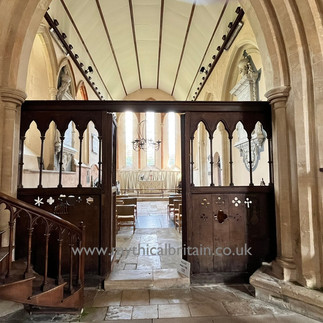 Wooden screen pierced by elegant arches leading to the chancel of the church