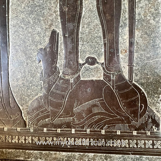 Detail of medieval brass showing a dog at a knight's feet