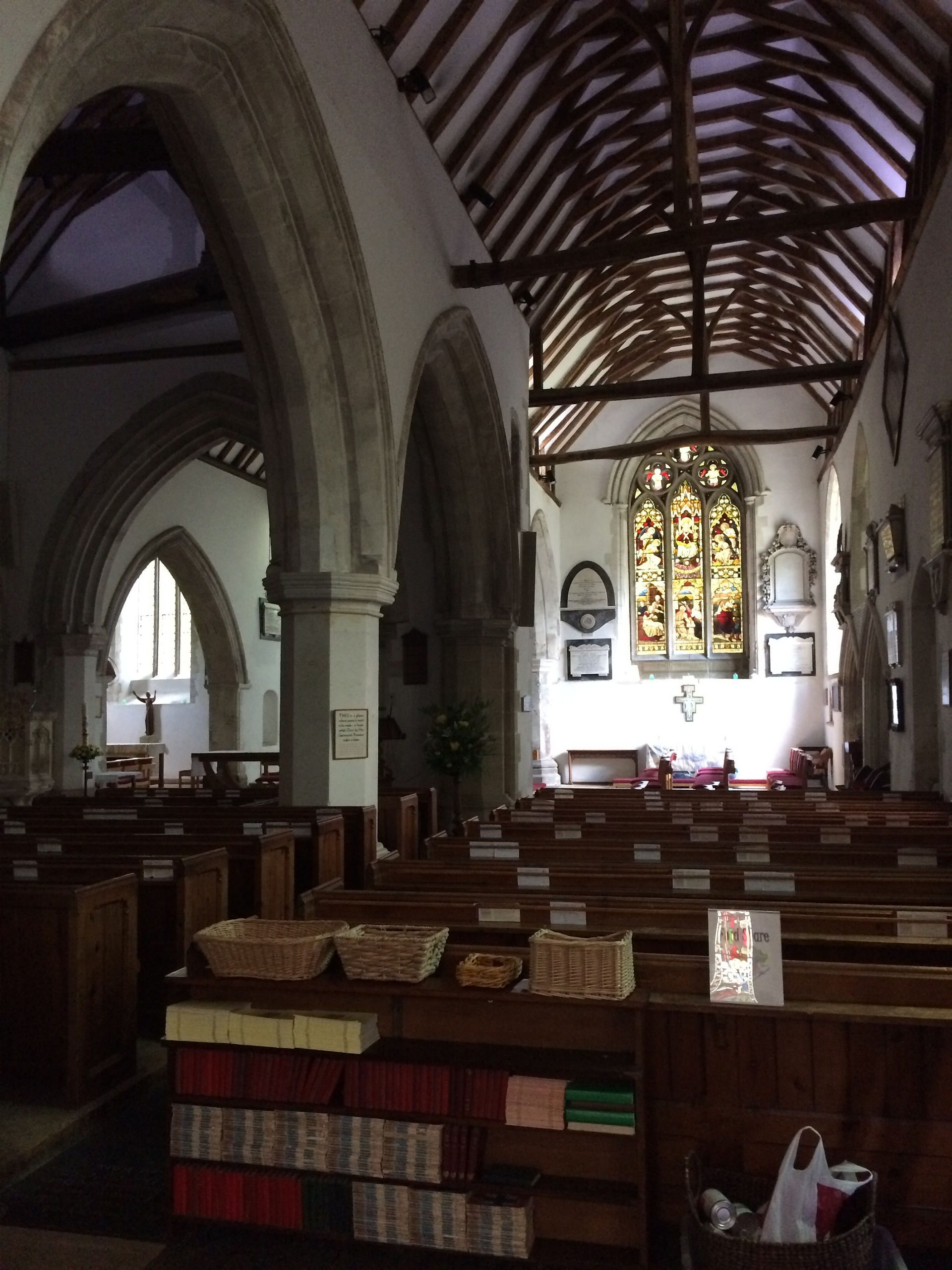 View of a church interior showing beamed roof and pews
