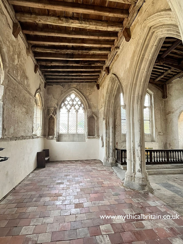 View towards a fourteenth century window with two fourteenth century archways opening up into the chancel on the right