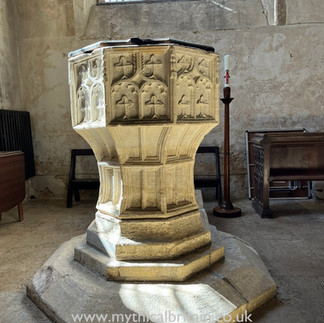 Font inside the church with window behind