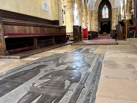 Nave of church showing medieval brass of knight and lady