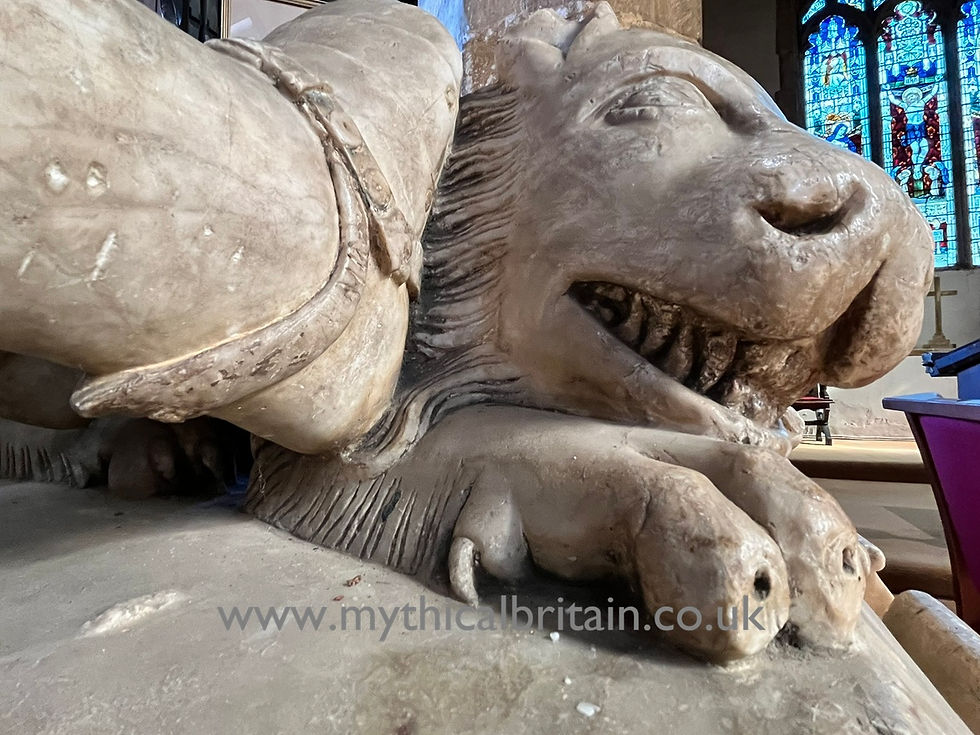 Close up of a carved lion at the feet of the effigy to Sir John Swinford, lord of the manor of Spratton.