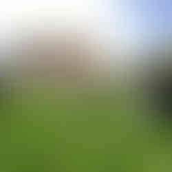 View of the eastern end of the church showing the chancel and, to its right, an extension added in 1494-1505. Gravestones are in the foreground.
