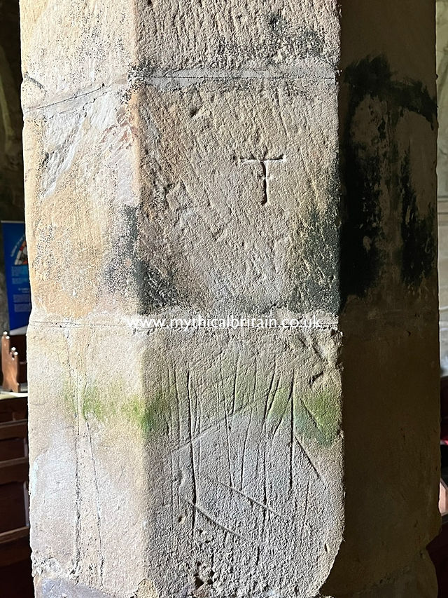 scratches in a pillar seemingly made by sharpening weapons