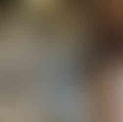 Worn medieval brasses shown on the floor, half covered by the wooden base of a church organ