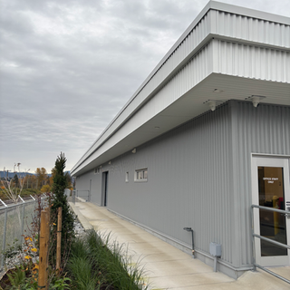 Multi-colour Westform metal siding and soffit with vent trims on a commercial car wash in the Fraser Valley, installed by West Royal Contracting Ltd.