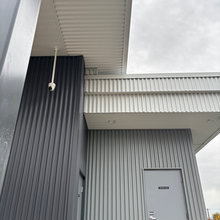 Concealed-fastener metal siding and soffit on steel-frame car wash by West Royal Contracting Ltd. in the Fraser Valley, BC.
