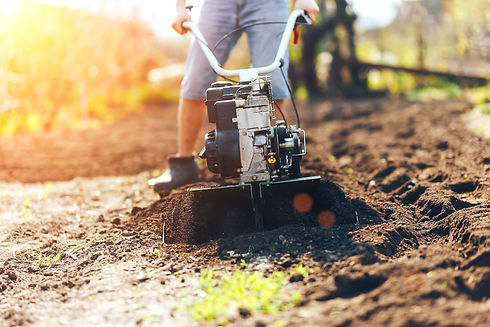 close up photo of young farmer gardener cultivate ground soil rototiller