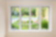 A picture showcasing big windows of a house with a lawn view