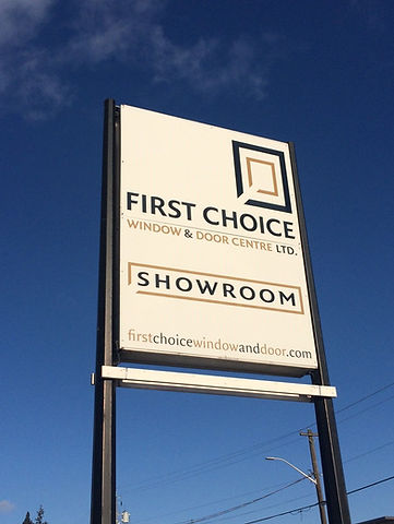 Billboard sign of First Choice Window & Door Centre Ltd. in front of showroom