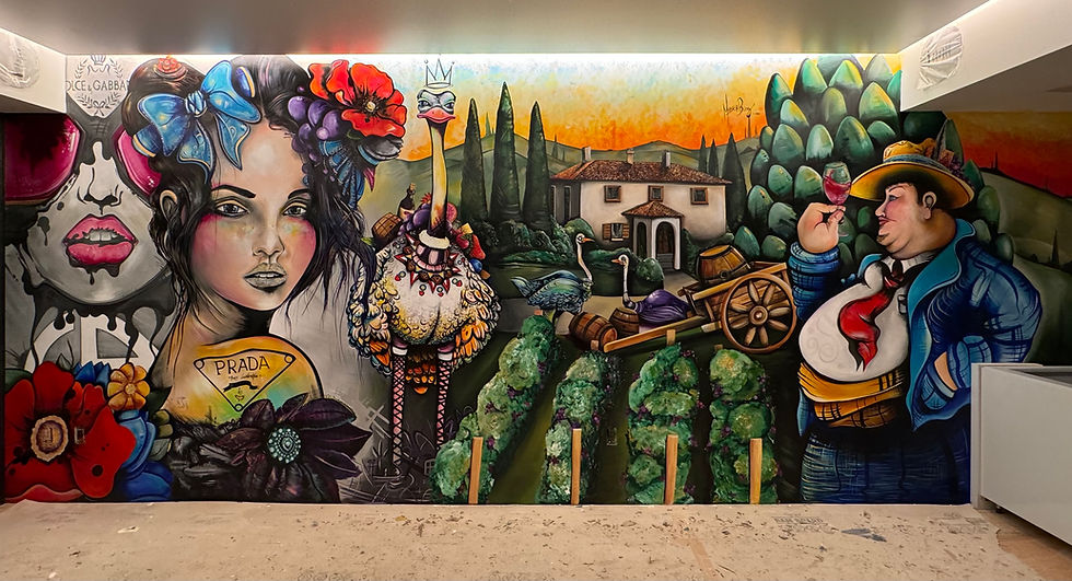 Fort Lauderdale Madonna by Moschburg, colorful interior mural showing a woman framed by oversized flowers and fashion motifs beside an ostrich, Tuscan villa and cypress landscape, vineyard rows, a wooden cart, and a man in blue tasting wine, 2025.