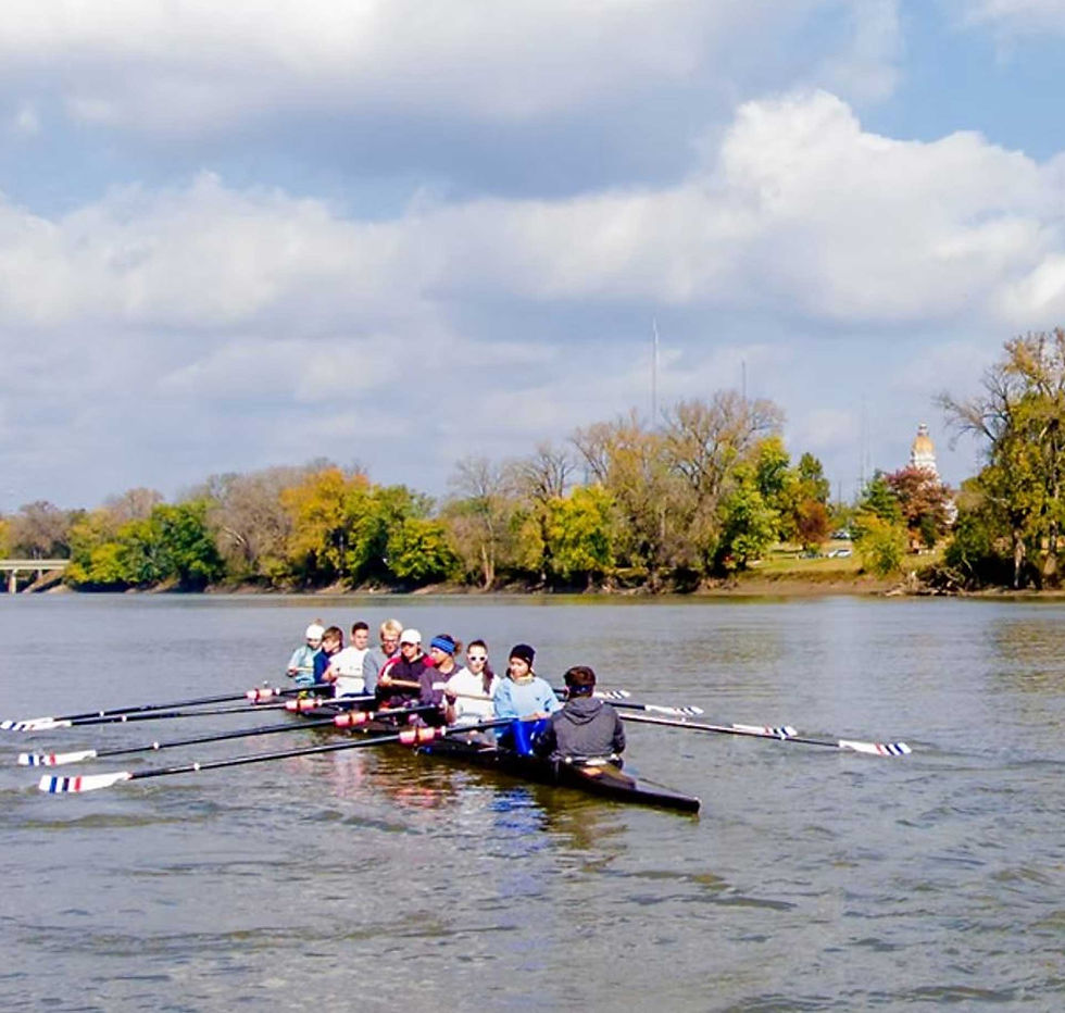 close-up shot of a group of people rowing on the river