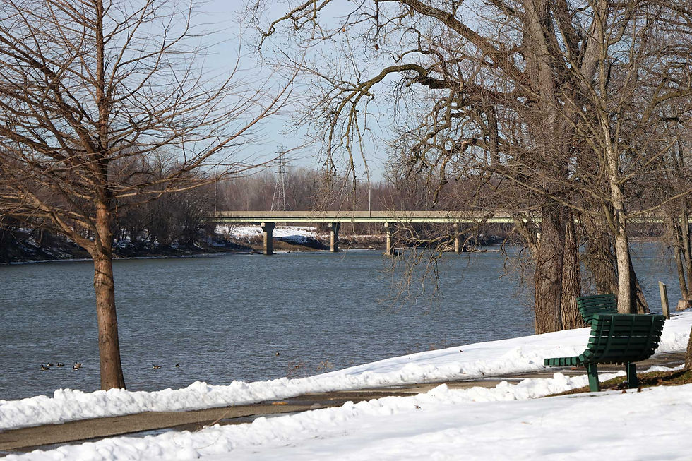 A view of the river in the winter with snow on the ground