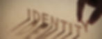IDENTITY wood word on compressed board with human's finger at Y letter_edited.jpg