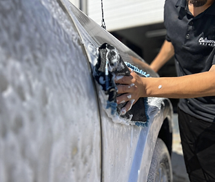 Soapy car wash in progress.png