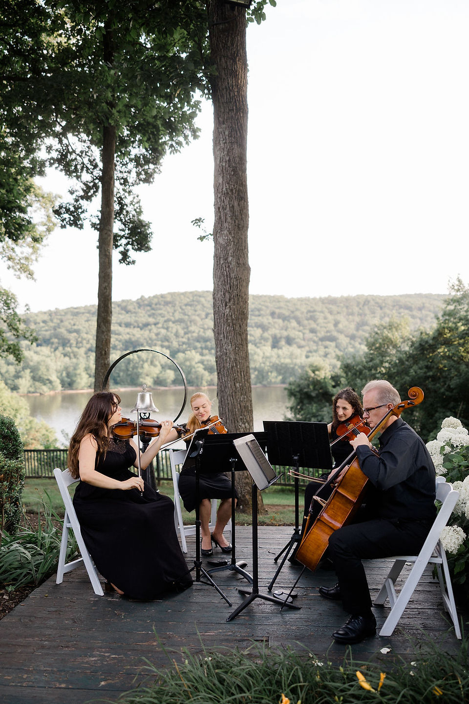 wedding string quartet performing for cocktail hour overlooking the Connecticut river at saint clements castle wedding in Portland connecticut