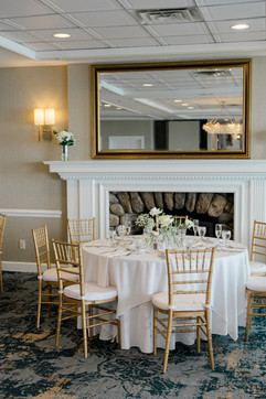 waters edge resort and spa wedding reception decor in front of the fireplace