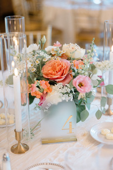 coral and pink floral centerpiece at saint clements castle wedding reception