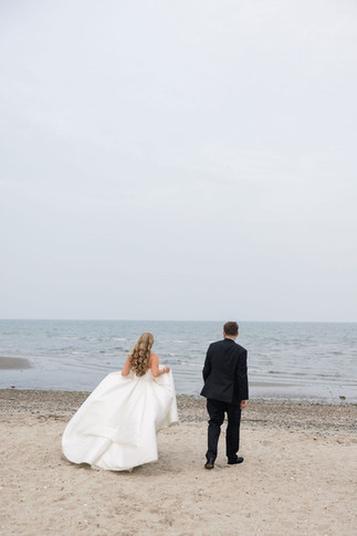 bride and groom walking on the beach after Tyde at Walnut Beach wedding